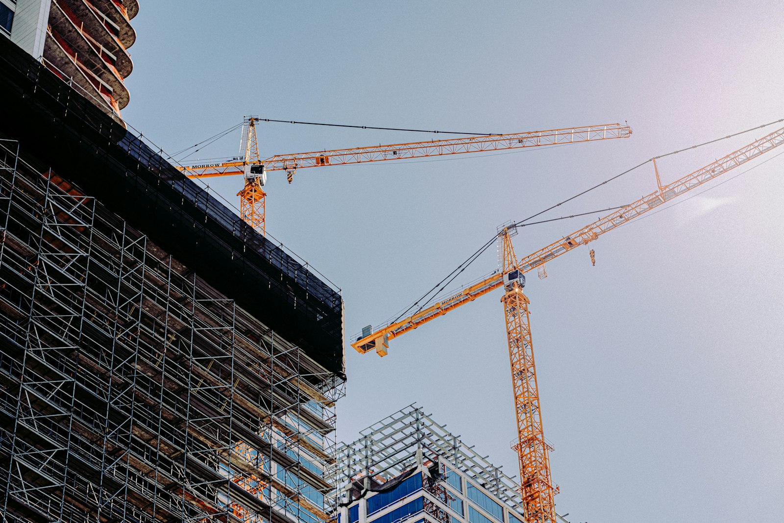 Tower crane rising over a building under construction