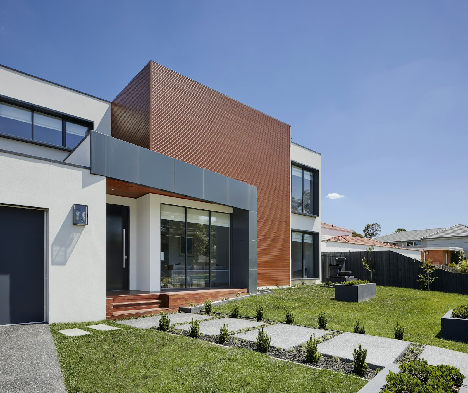 Modern two-storey house with wood cladding