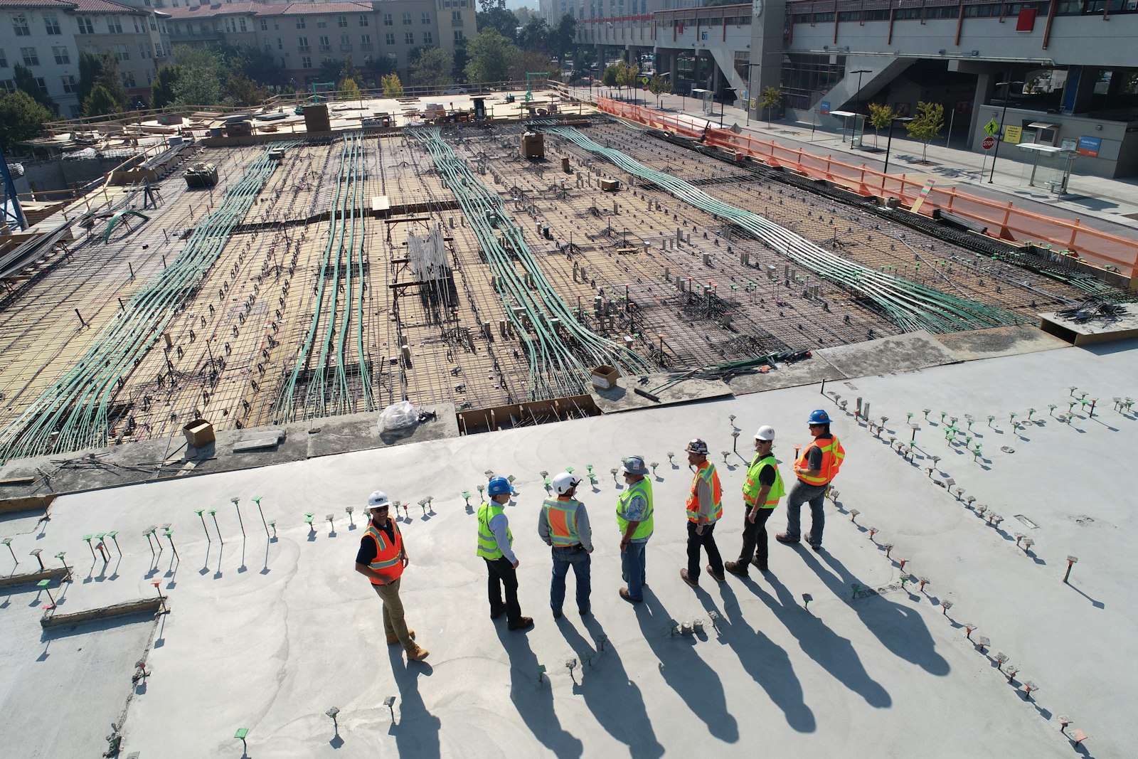 Site crew in hard hats reviewing work